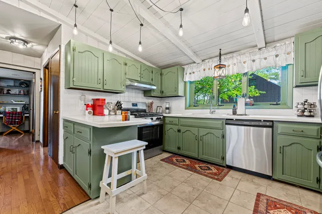 a bed sitting in a bedroom next to a bathroom
