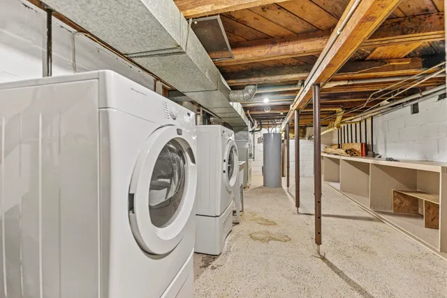 a front view of a house with a garden and trees