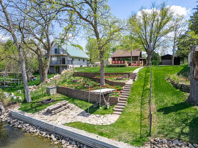 an aerial view of a house with a yard basket ball court and outdoor seating