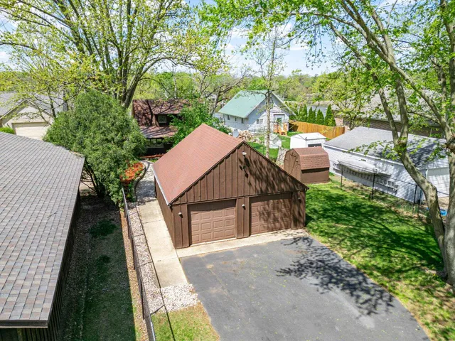 an aerial view of a residential houses with outdoor space and river view