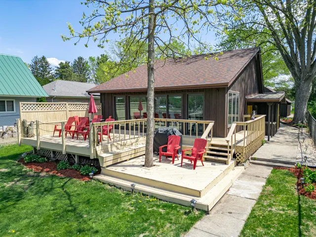 an aerial view of residential houses with outdoor space and swimming pool