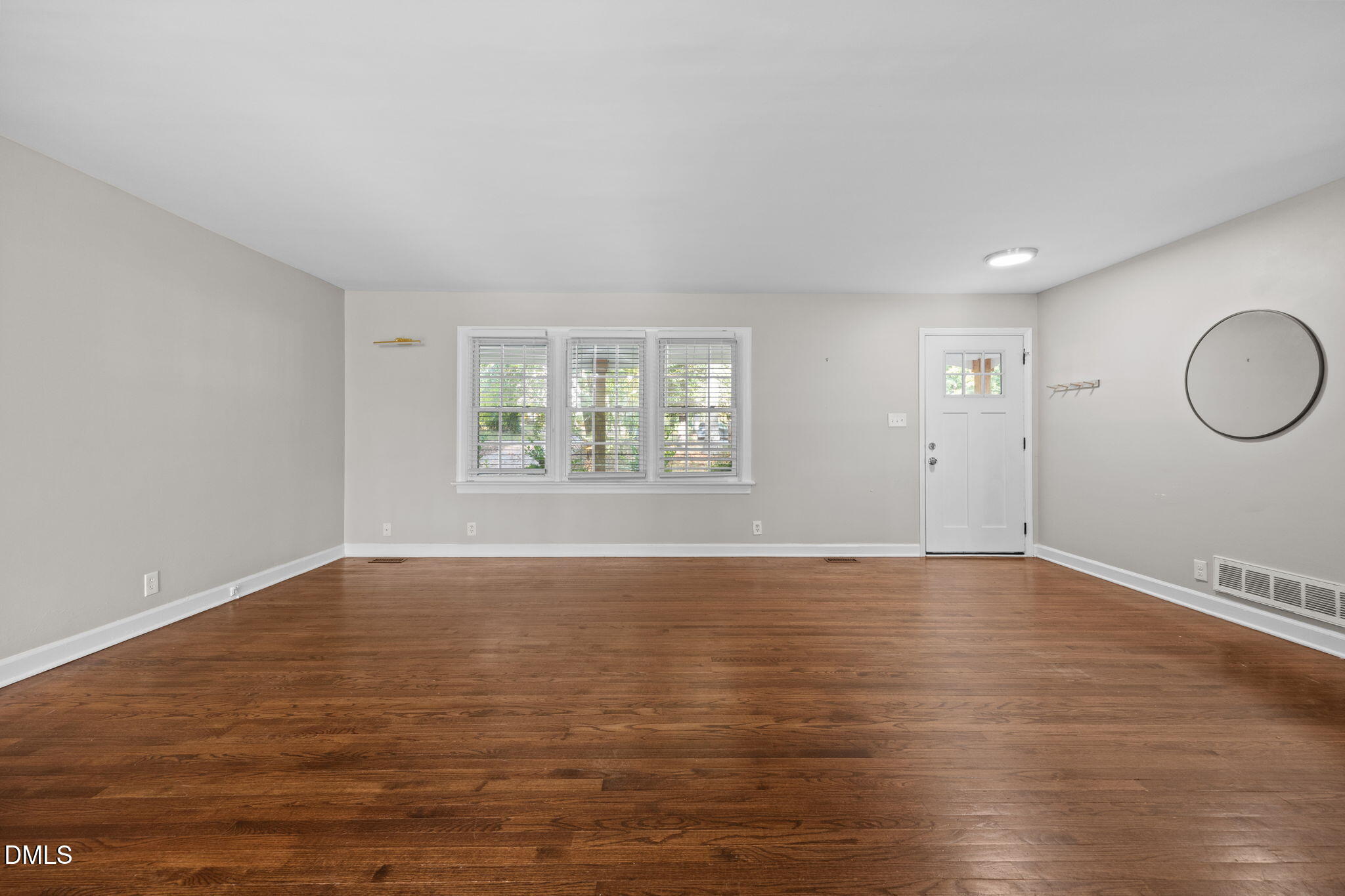 2950 Glenridge Drive Raleigh, NC 27604 - Photo 17 of 53 a view of an empty room with wooden floor and window