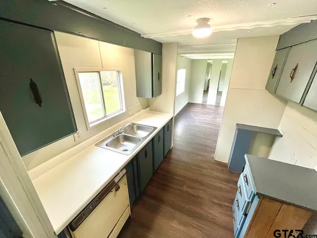 a living room with wooden floor and furniture