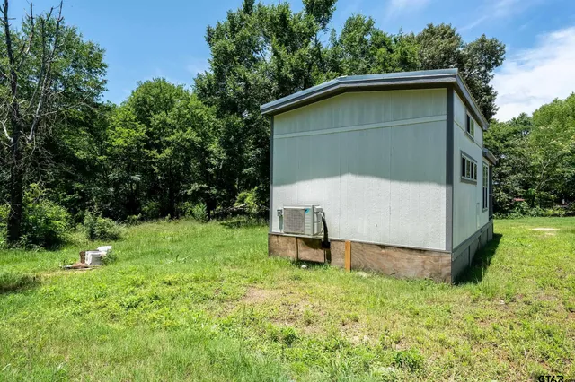 a house with green field in front of it