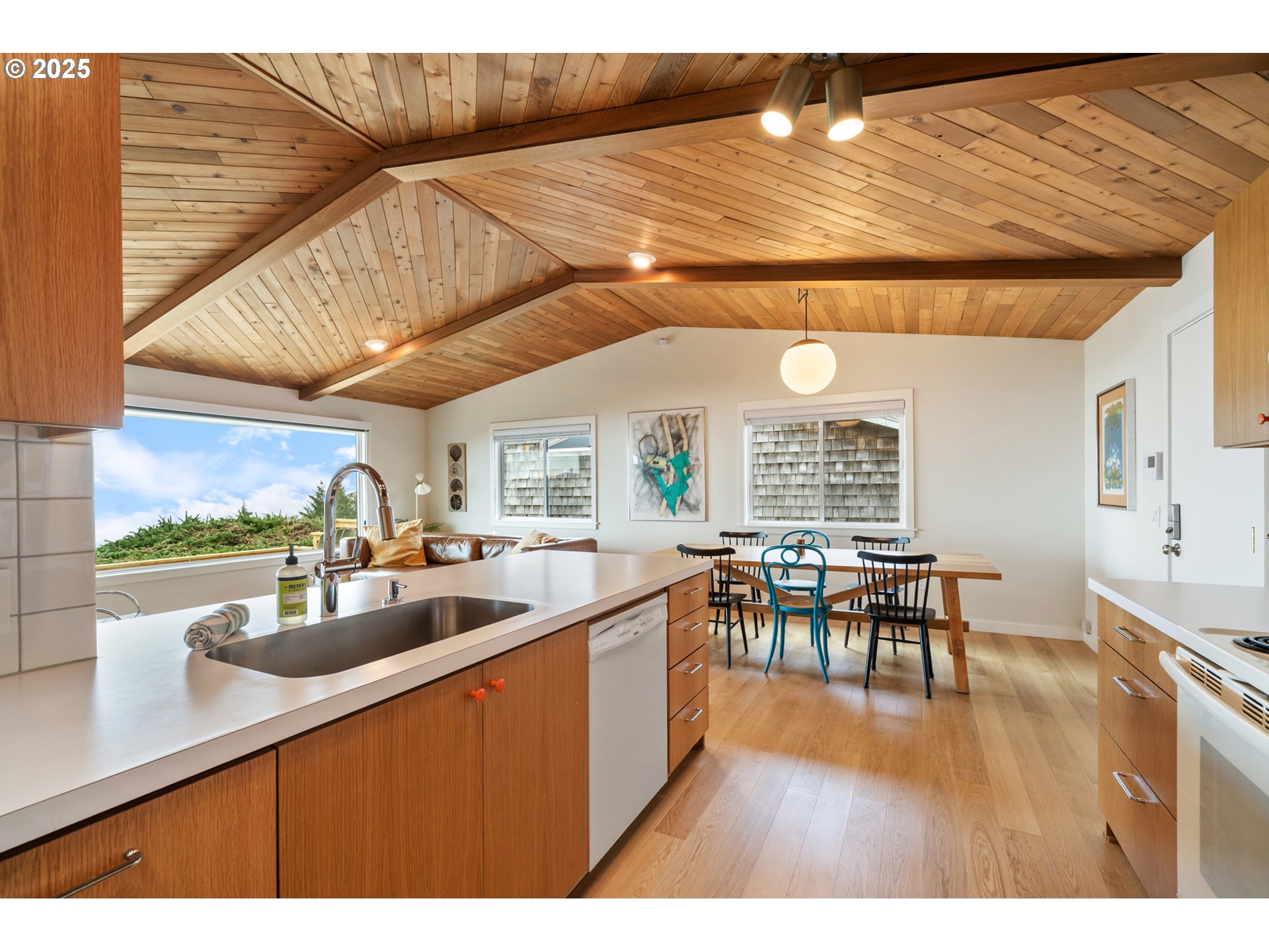 1100 Arthurs Road Oceanside, OR 97141 - Photo 18 of 48 a kitchen with a table chairs and wooden floor