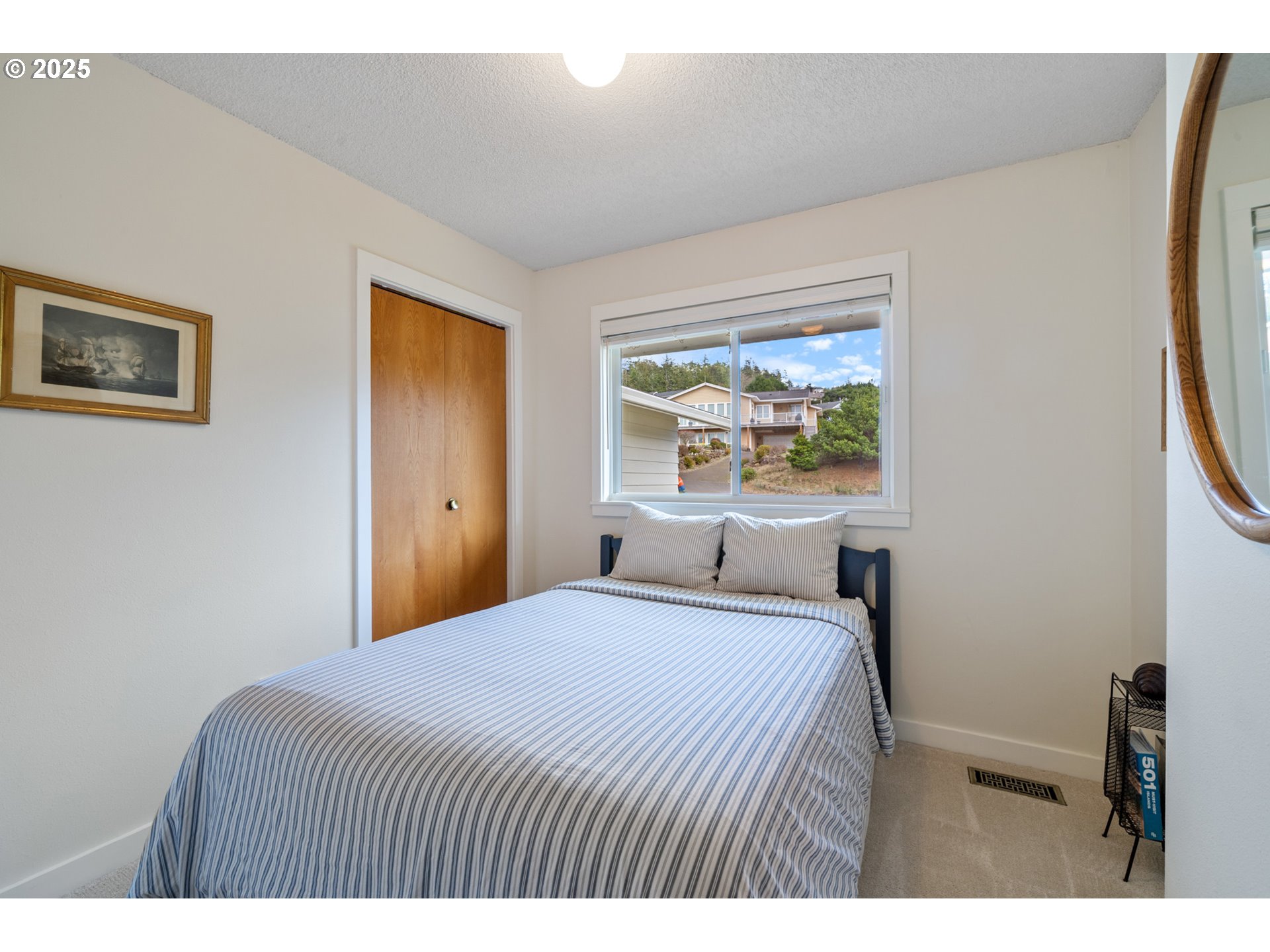 1100 Arthurs Road Oceanside, OR 97141 - Photo 30 of 48 a bedroom with a bed and a window
