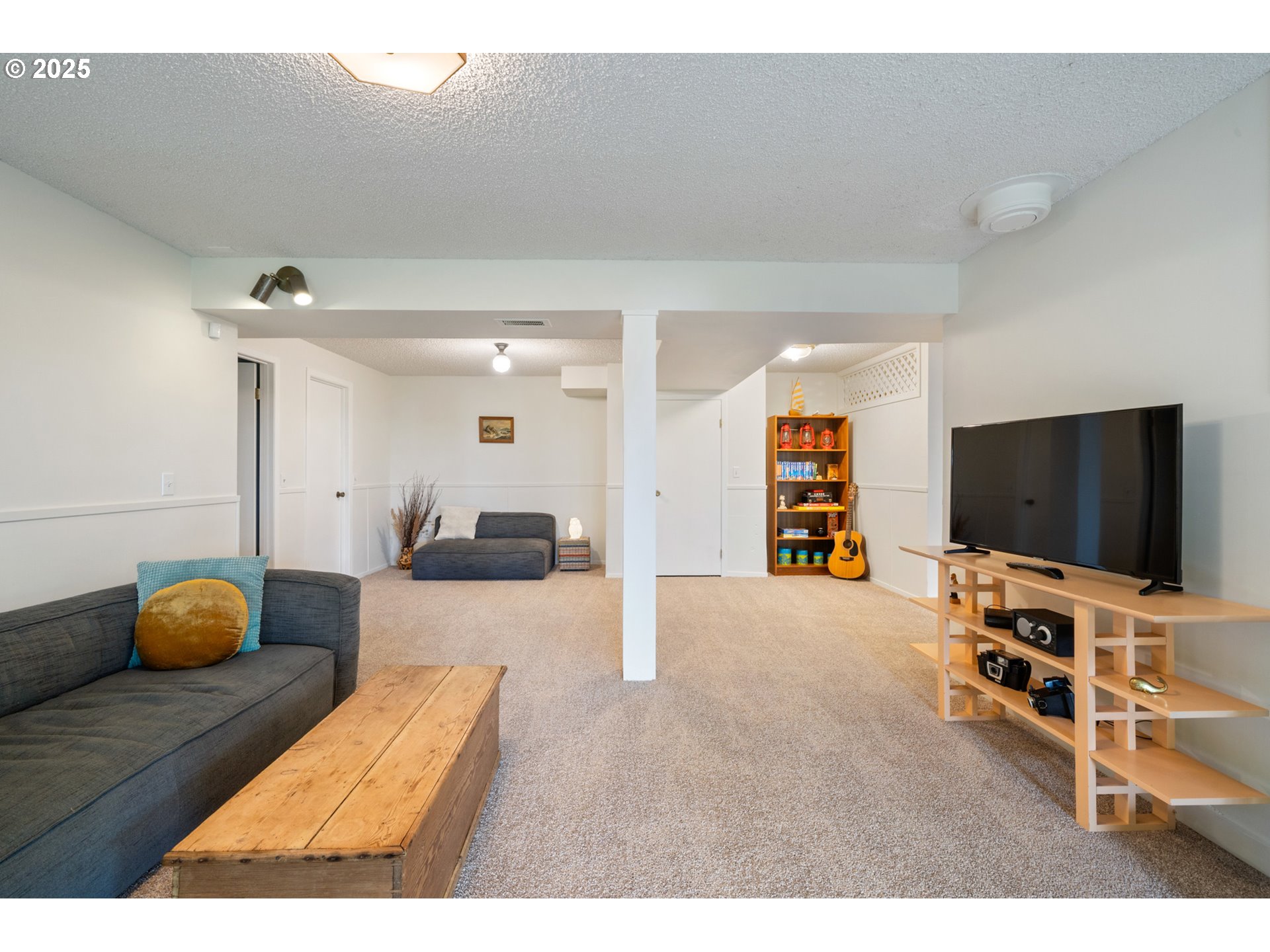 1100 Arthurs Road Oceanside, OR 97141 - Photo 34 of 48 a living room with furniture and a flat screen tv