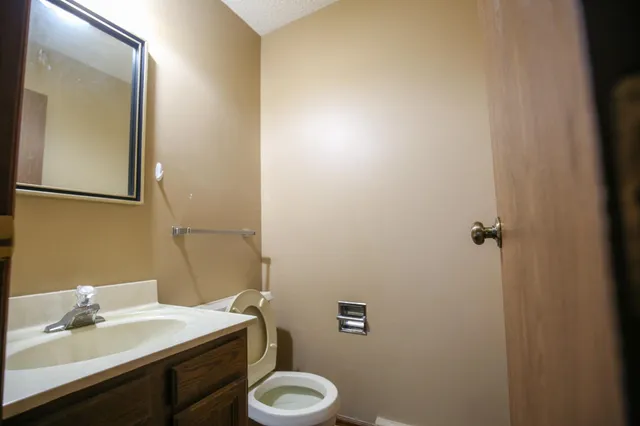 a bathroom with a sink toilet and mirror