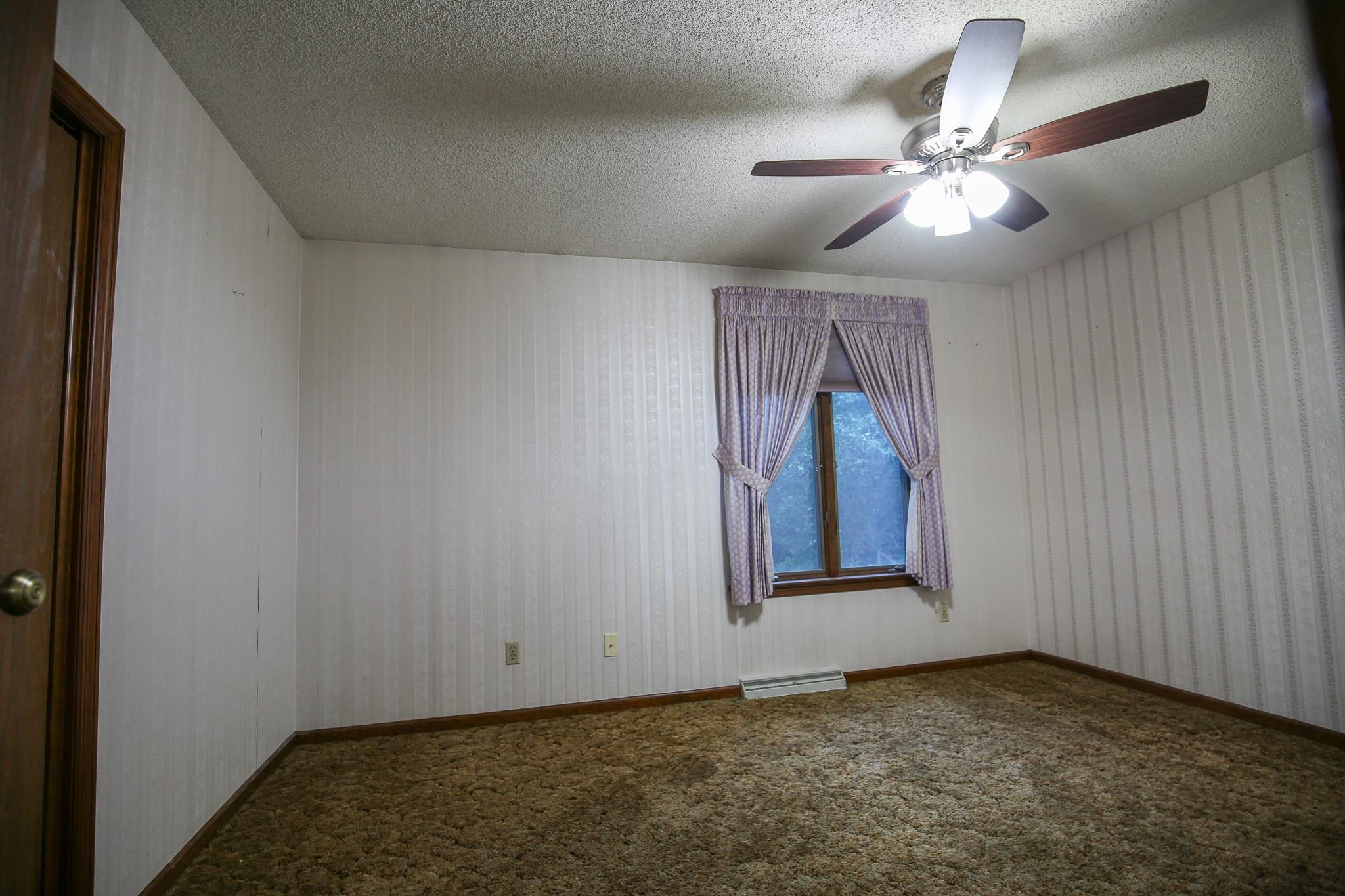 209 Fox Trot Dixon, IL 61021 - Photo 18 of 34 an empty room with windows and fan