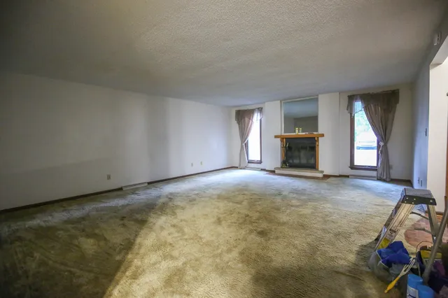 a view of empty room with a fireplace