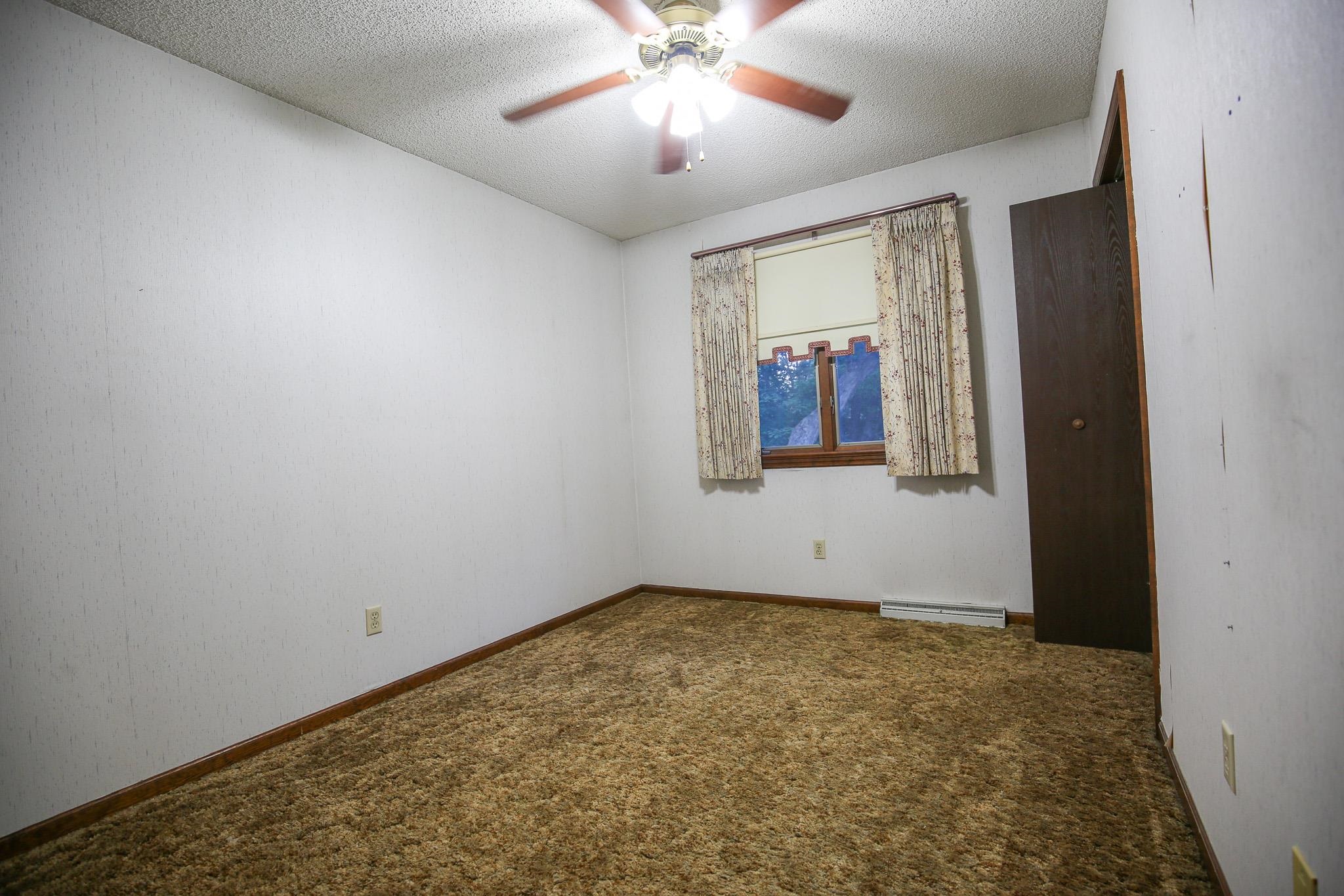 209 Fox Trot Dixon, IL 61021 - Photo 28 of 34 an empty room with window and ceiling fan