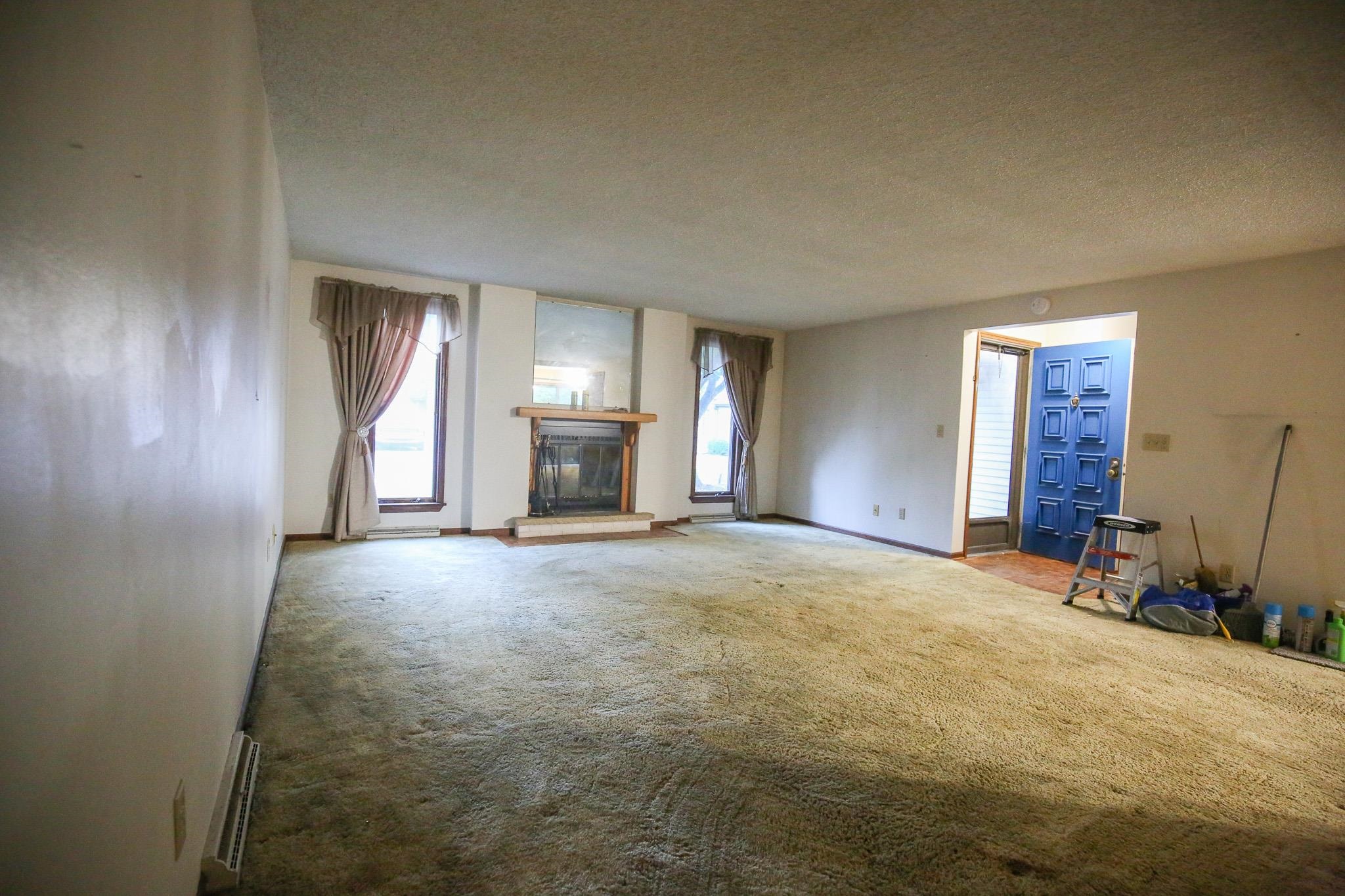 209 Fox Trot Dixon, IL 61021 - Photo 10 of 34 an empty room with fireplace and windows