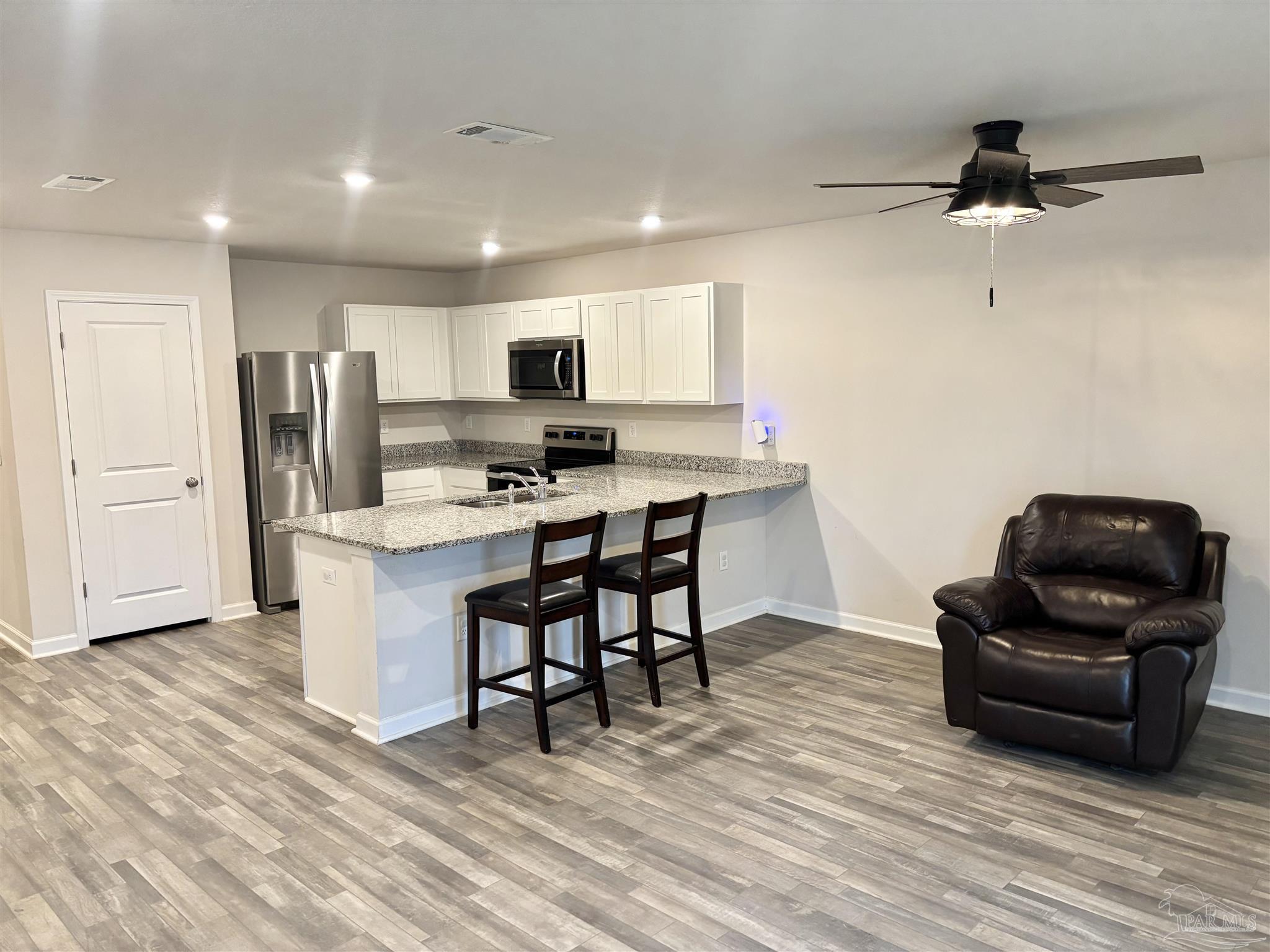 2164 Pineview Church Road Jay, FL 32565 - Photo 5 of 24 a living room with stainless steel appliances furniture and a wooden floor