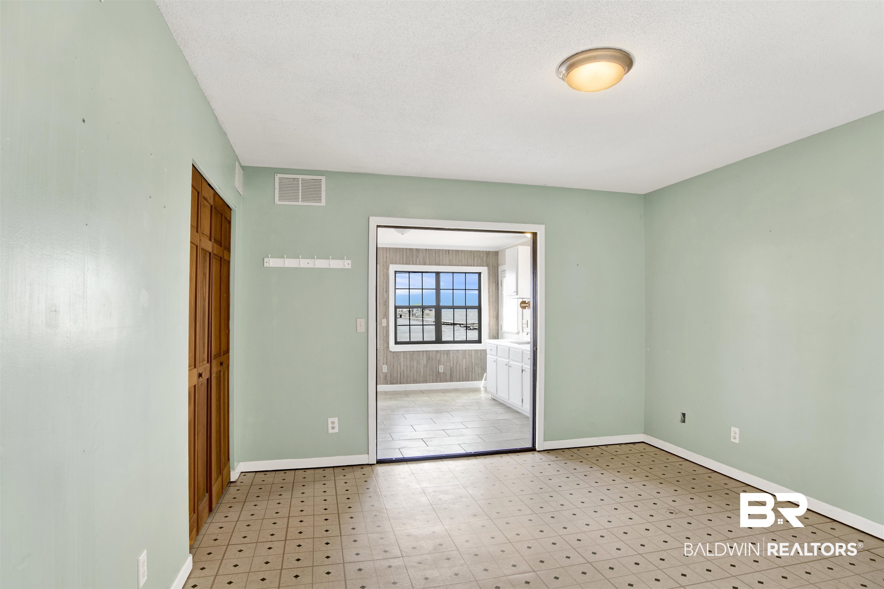 7411 Bay Road Mobile, AL 36605 - Photo 31 of 34 Empty room with light floors and baseboards
