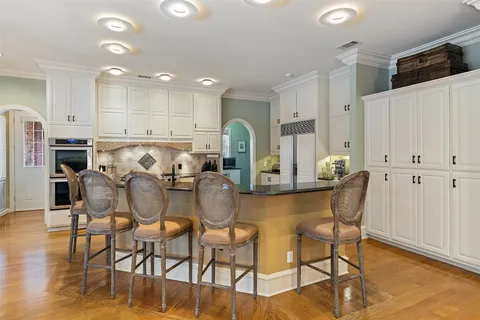 a bathroom with a granite countertop toilet sink and mirror