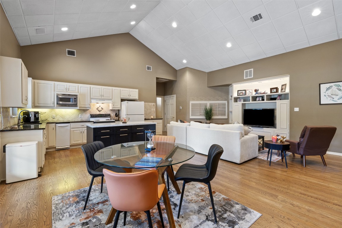 118 Lido Street Austin, TX 78734 - Photo 29 of 40 a living room with stainless steel appliances kitchen island dining table wooden floor and kitchen view