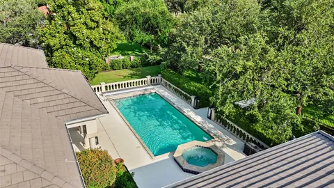 a living room with furniture a fireplace and a large window