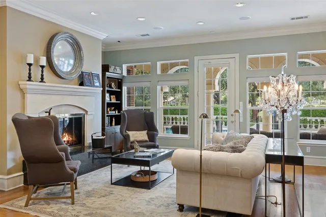 a view of a dining room with furniture a chandelier and wooden floor