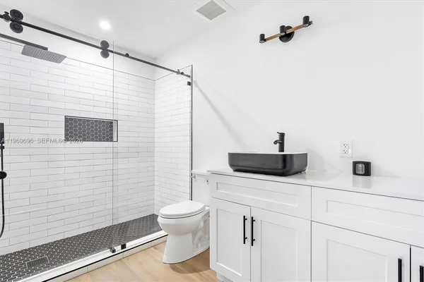 a bathroom with a sink a toilet and a mirror