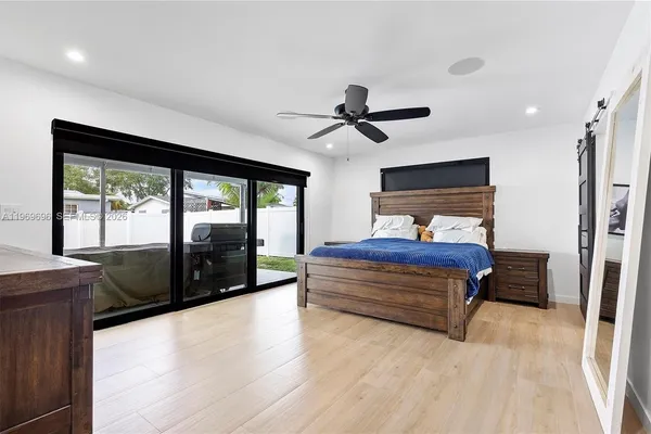 a bedroom with a large bed and a large window