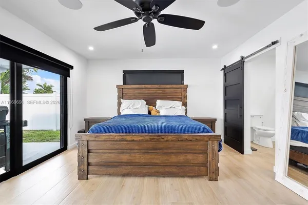 a bedroom with a bed and a large window