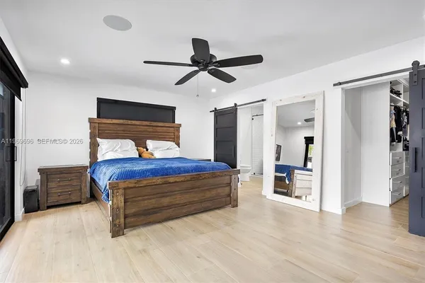a bedroom with a bed and a chandelier