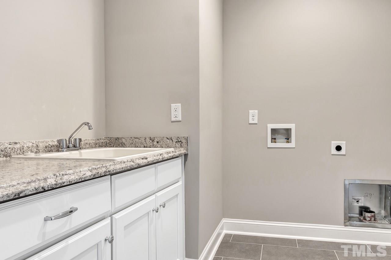 6733 Dwight Rowland Road Willow Spring, NC 27592 - Photo 17 of 25 enclosed laundry tub, tiled flooring