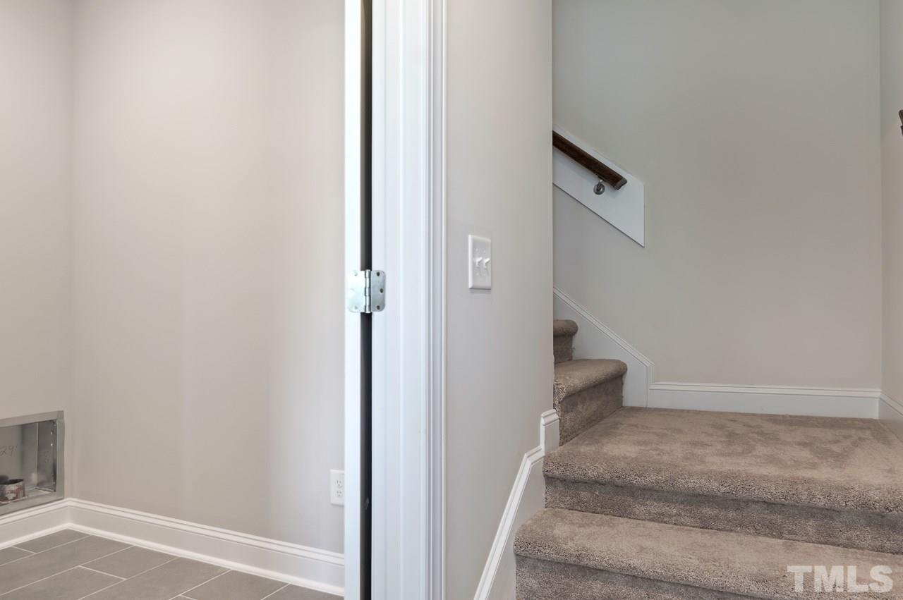 6733 Dwight Rowland Road Willow Spring, NC 27592 - Photo 18 of 25 Landing makes easier climbing w shorter steps and laundry room is located first floor at the garage