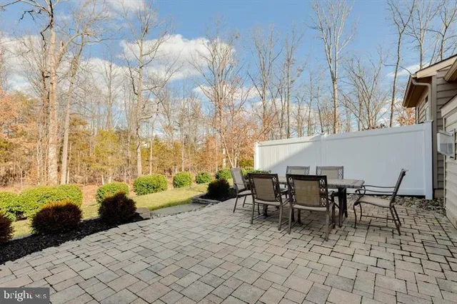 a view of a patio with table and chairs and potted plants