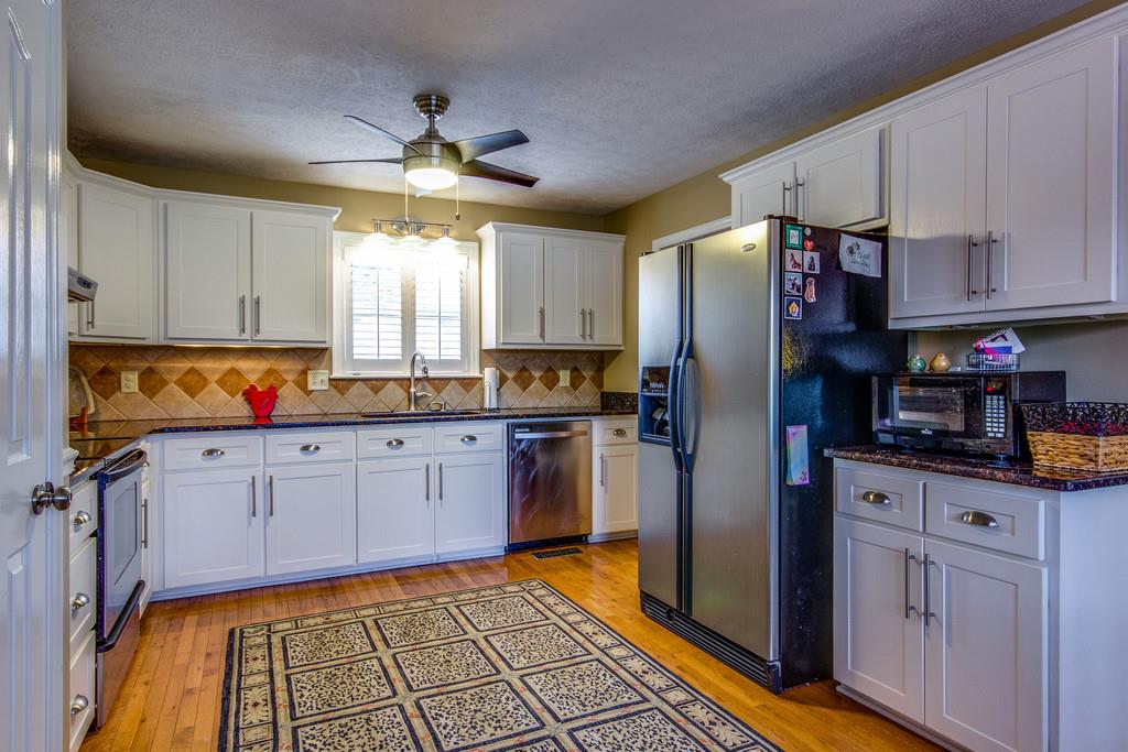 4021 Trinity Road Franklin, TN 37067 - Photo 16 of 30 a kitchen with granite countertop stainless steel appliances a stove refrigerator and cabinets