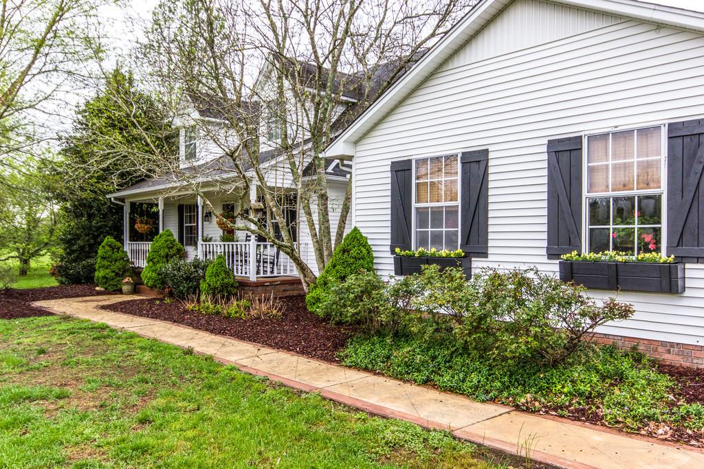 4021 Trinity Road Franklin, TN 37067 - Photo 5 of 30 a view of a house with brick walls and a yard with plants