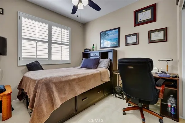 a bedroom with a bed and a desk