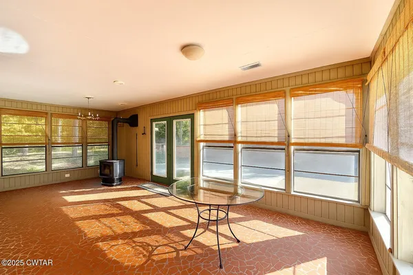 a spacious bedroom with a large window and a table
