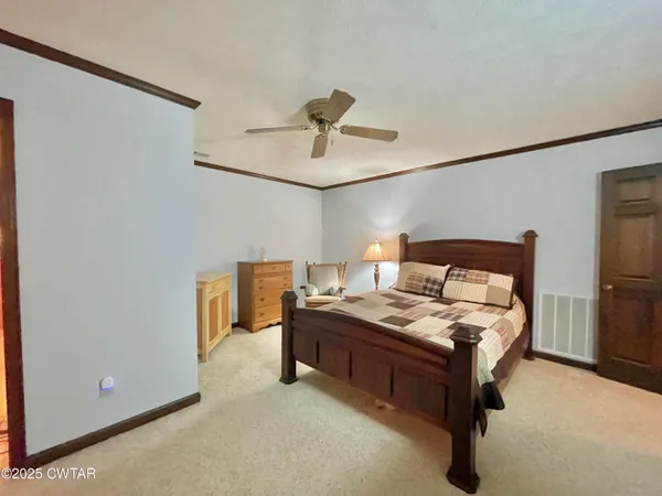 a bed room with a bed and a chandelier