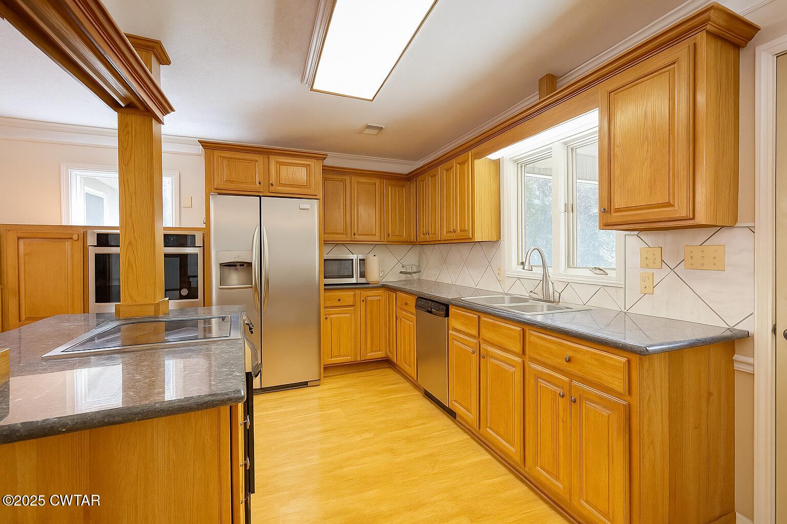 459 Liberty Road Beech Bluff, TN 38313 - Photo 9 of 32 a kitchen with stainless steel appliances granite countertop a sink refrigerator and cabinets