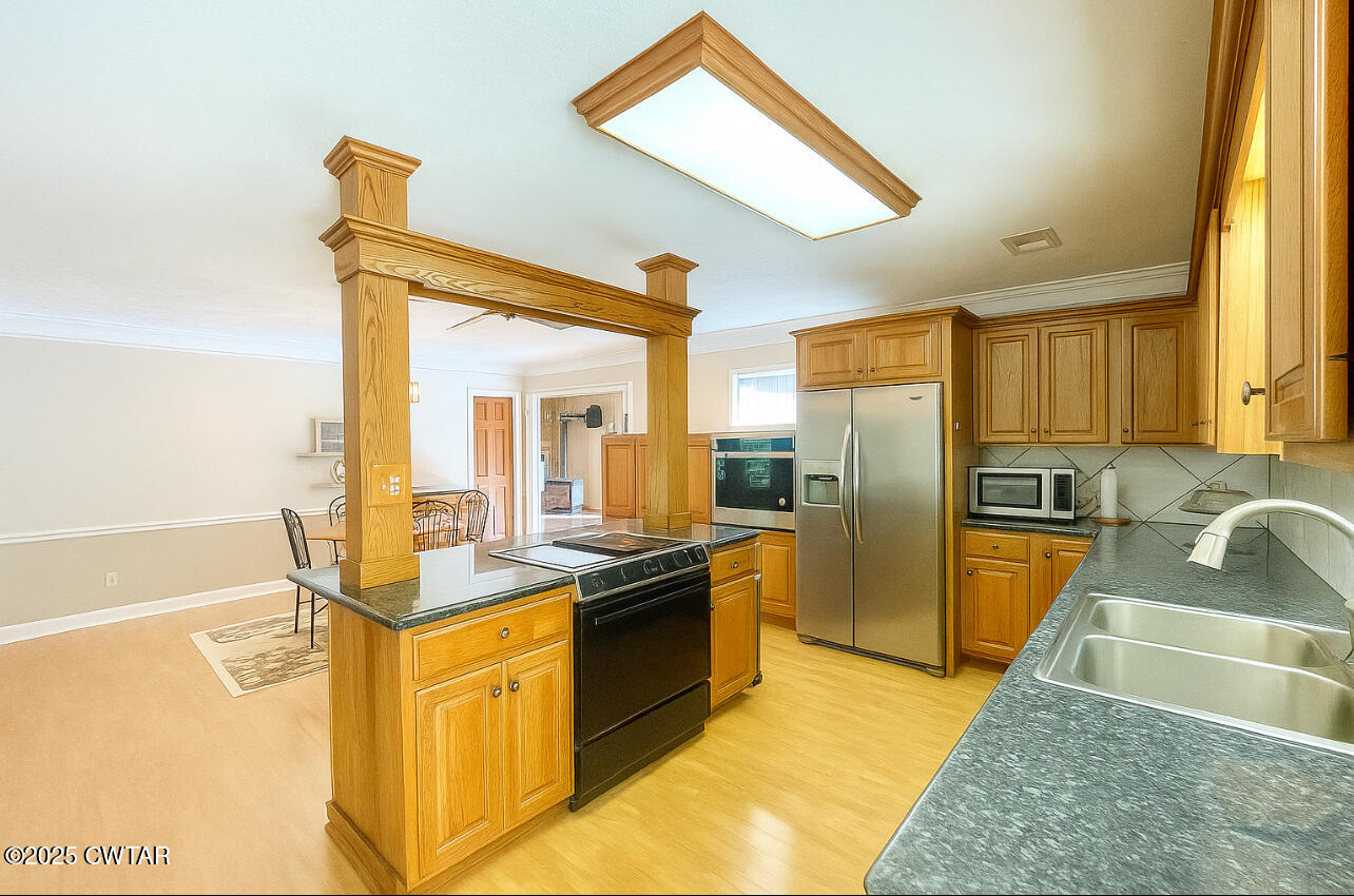 459 Liberty Road Beech Bluff, TN 38313 - Photo 10 of 32 a kitchen with stainless steel appliances granite countertop a sink stove and refrigerator