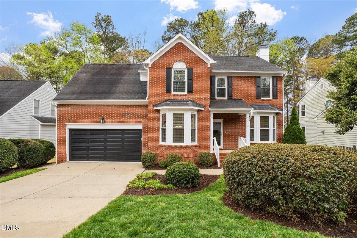2628 Crofton Springs Drive Raleigh, NC 27615 - Photo 1 of 33 a front view of a house with a yard and garage
