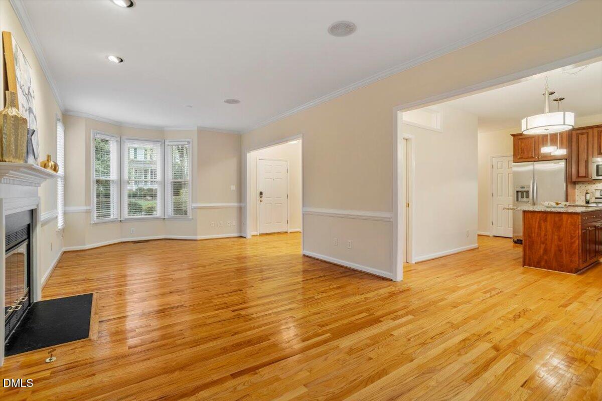 2628 Crofton Springs Drive Raleigh, NC 27615 - Photo 11 of 33 a view of an empty room with wooden floor and a window