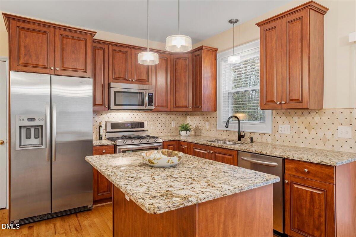 2628 Crofton Springs Drive Raleigh, NC 27615 - Photo 15 of 33 a kitchen with stainless steel appliances granite countertop a sink stove and refrigerator