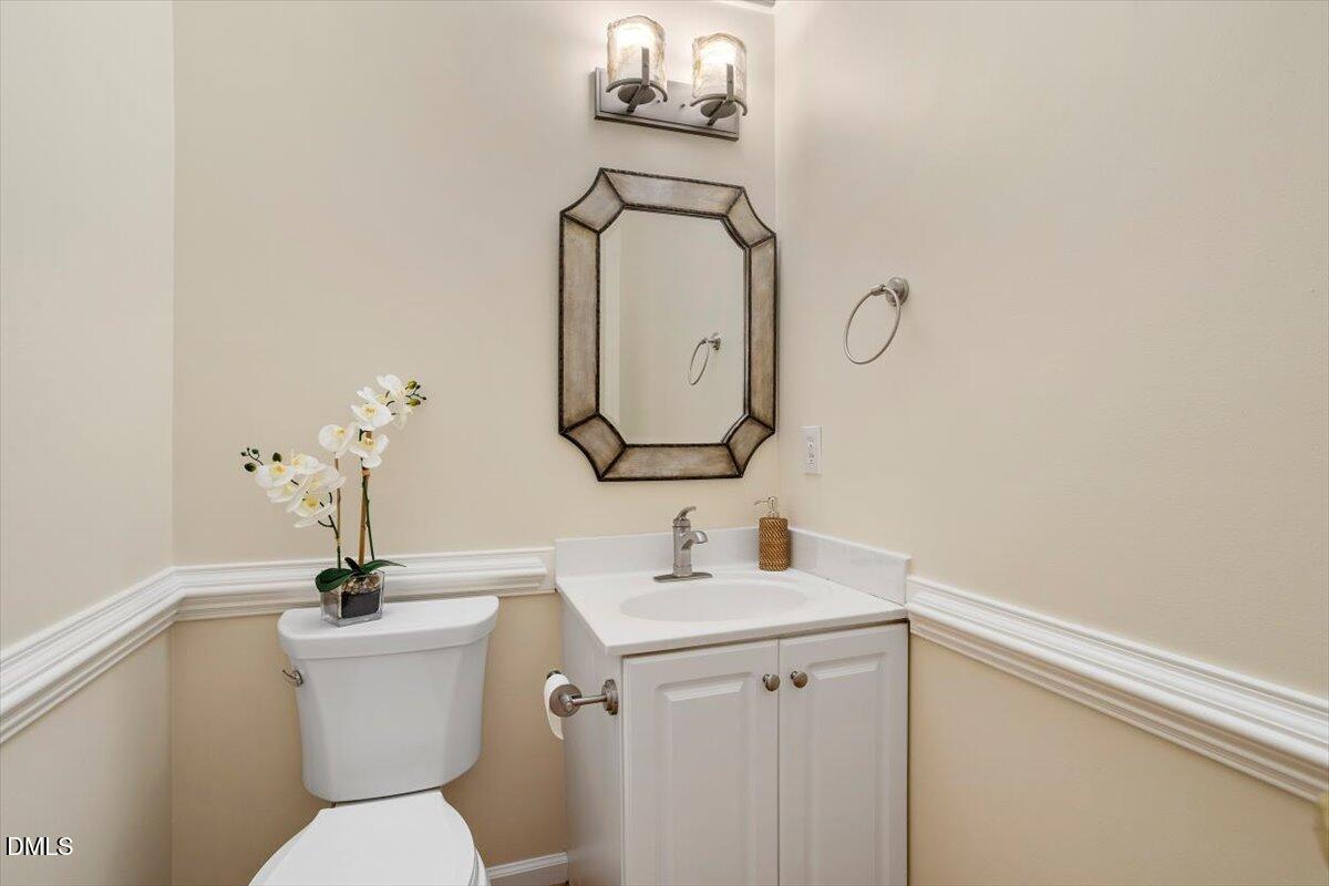 2628 Crofton Springs Drive Raleigh, NC 27615 - Photo 17 of 33 a bathroom with a toilet a sink and mirror