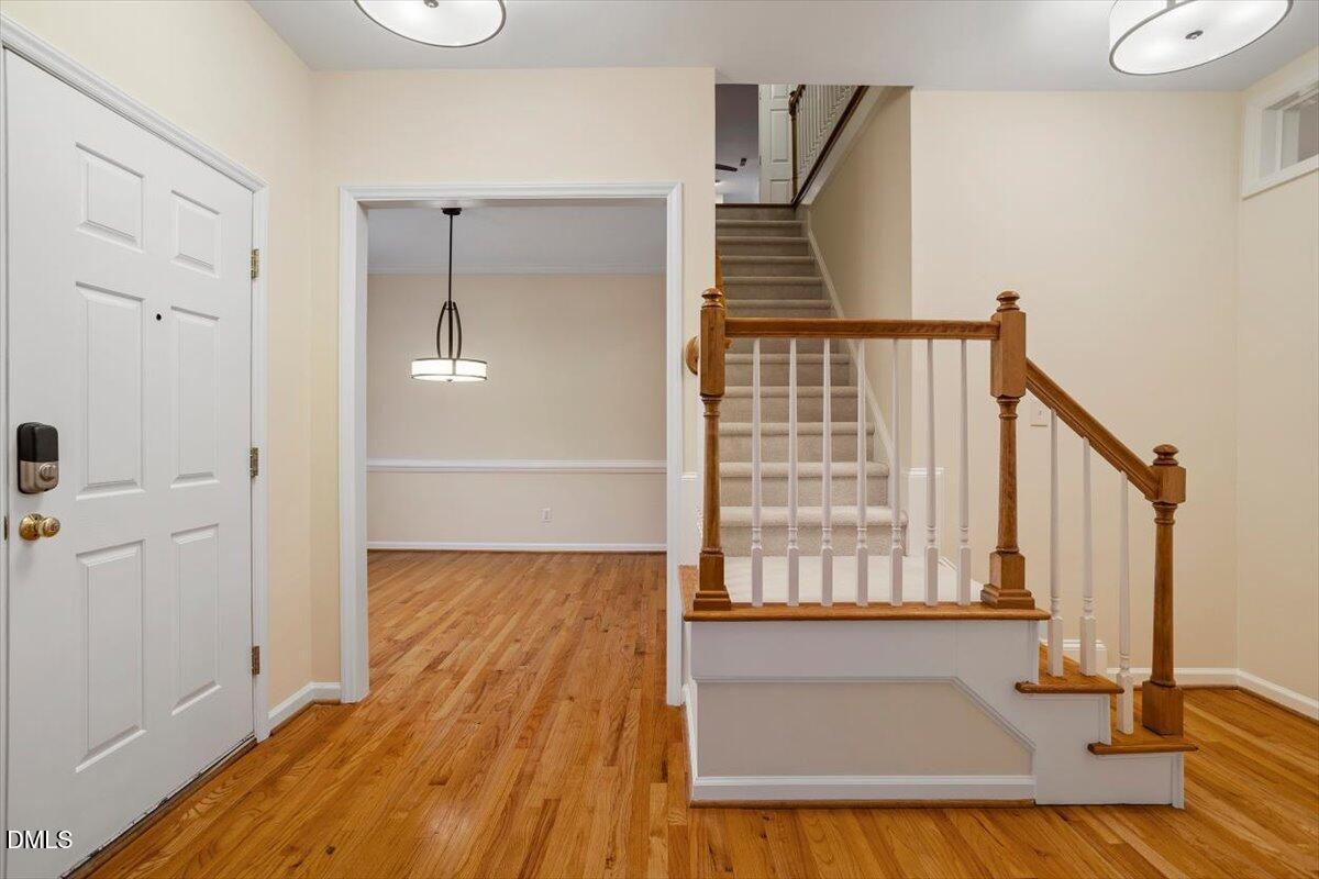 2628 Crofton Springs Drive Raleigh, NC 27615 - Photo 18 of 33 a view of an empty room with wooden floor and a window