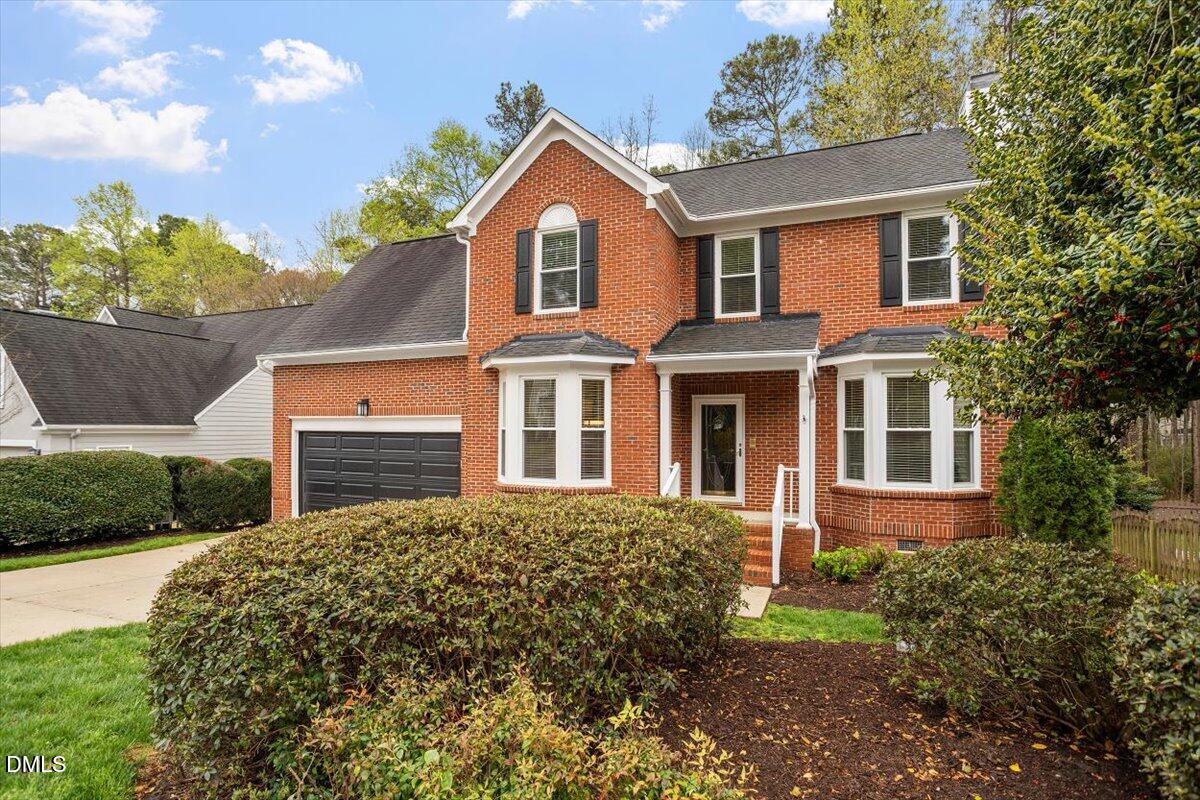 2628 Crofton Springs Drive Raleigh, NC 27615 - Photo 2 of 33 a front view of a house with a garden