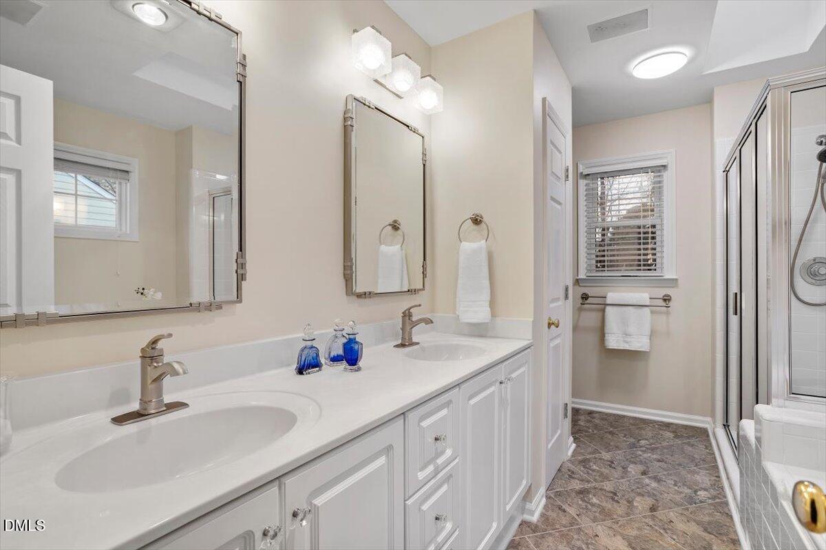 2628 Crofton Springs Drive Raleigh, NC 27615 - Photo 21 of 33 a bathroom with a double vanity sink mirror and double