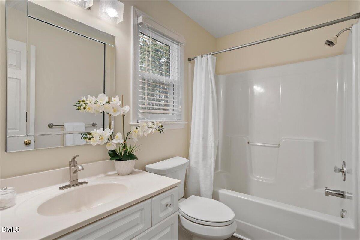 2628 Crofton Springs Drive Raleigh, NC 27615 - Photo 29 of 33 a bathroom with a sink a toilet and shower