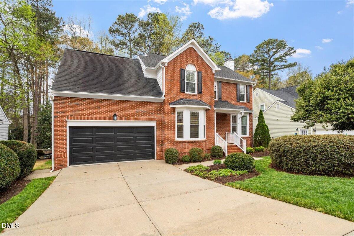 2628 Crofton Springs Drive Raleigh, NC 27615 - Photo 3 of 33 a front view of a house with a yard and garage