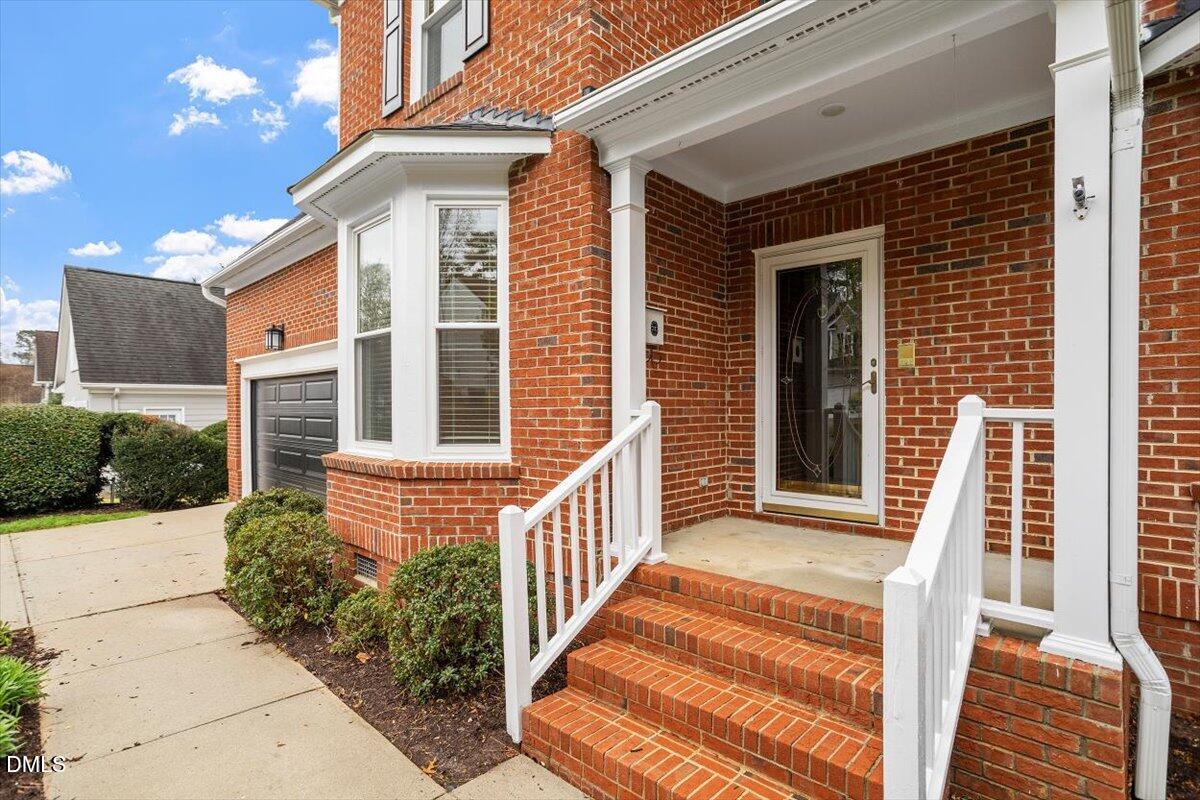 2628 Crofton Springs Drive Raleigh, NC 27615 - Photo 4 of 33 a front view of a house with a porch
