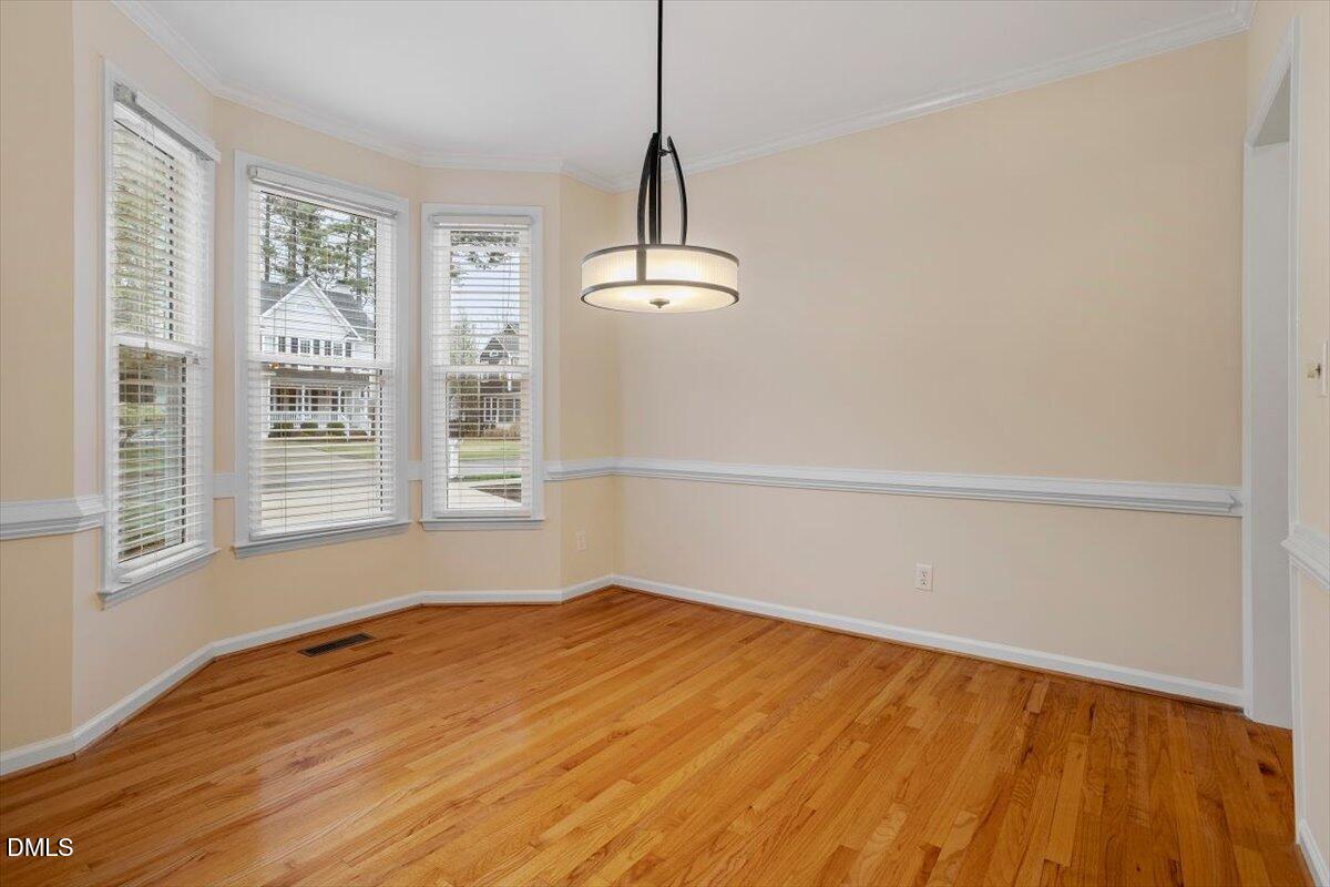 2628 Crofton Springs Drive Raleigh, NC 27615 - Photo 5 of 33 a view of a room with wooden floor and windows