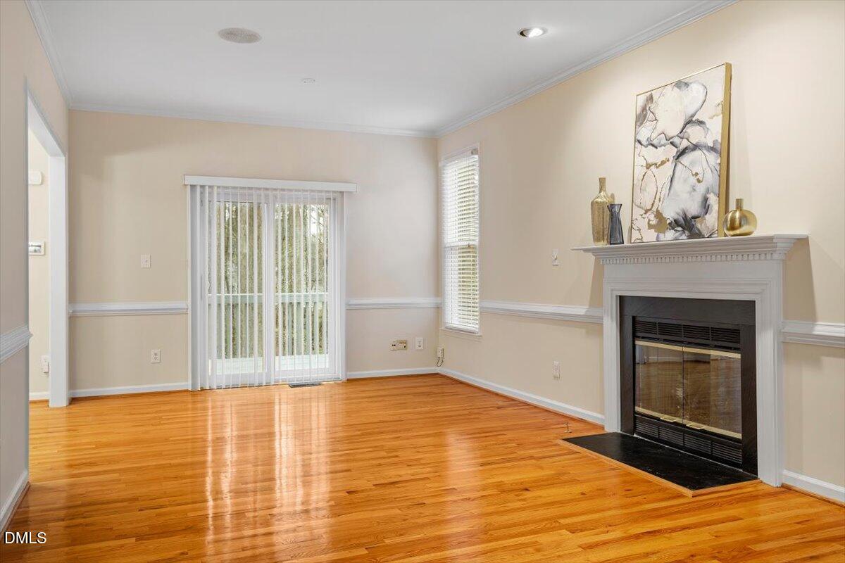 2628 Crofton Springs Drive Raleigh, NC 27615 - Photo 9 of 33 a view of an empty room with a fireplace and a window