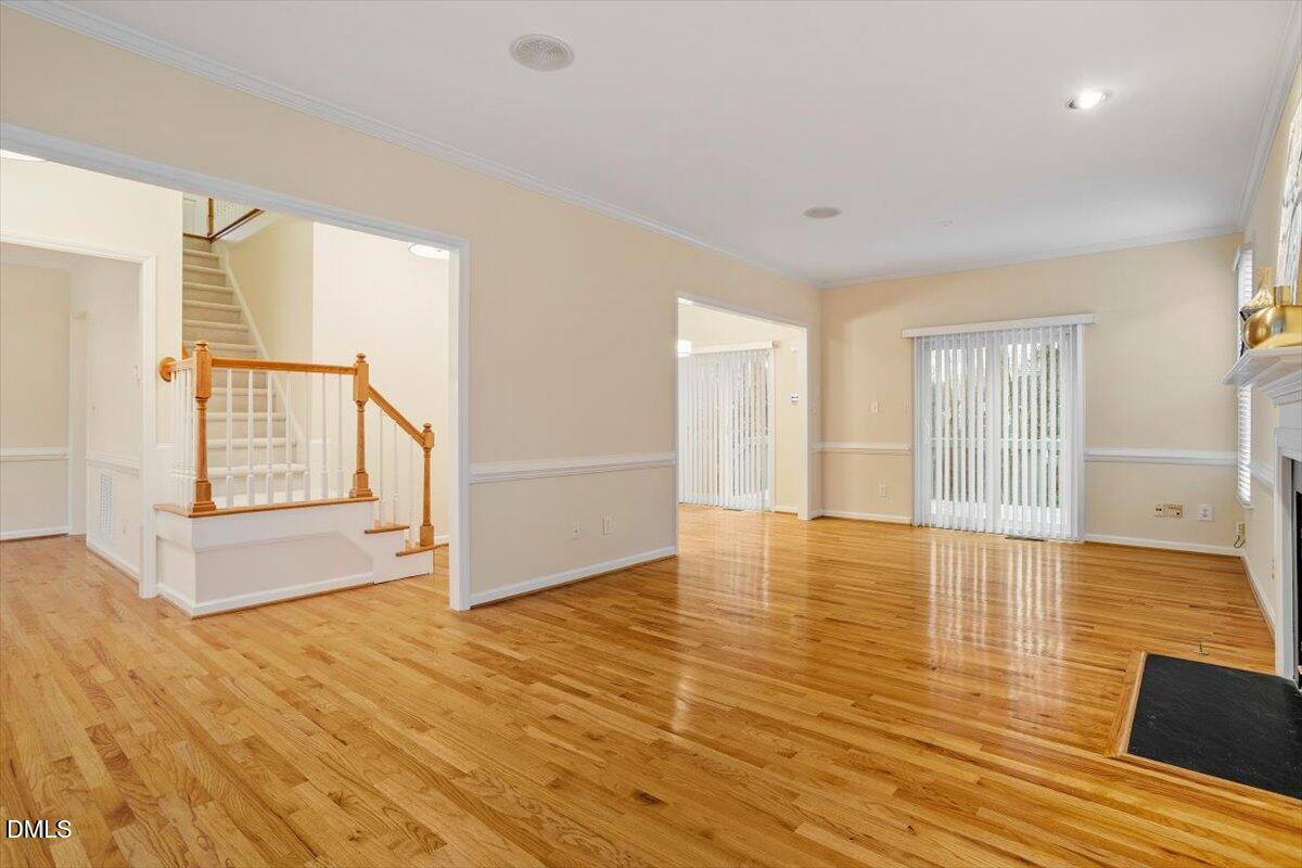 2628 Crofton Springs Drive Raleigh, NC 27615 - Photo 10 of 33 an empty room with wooden floor and windows