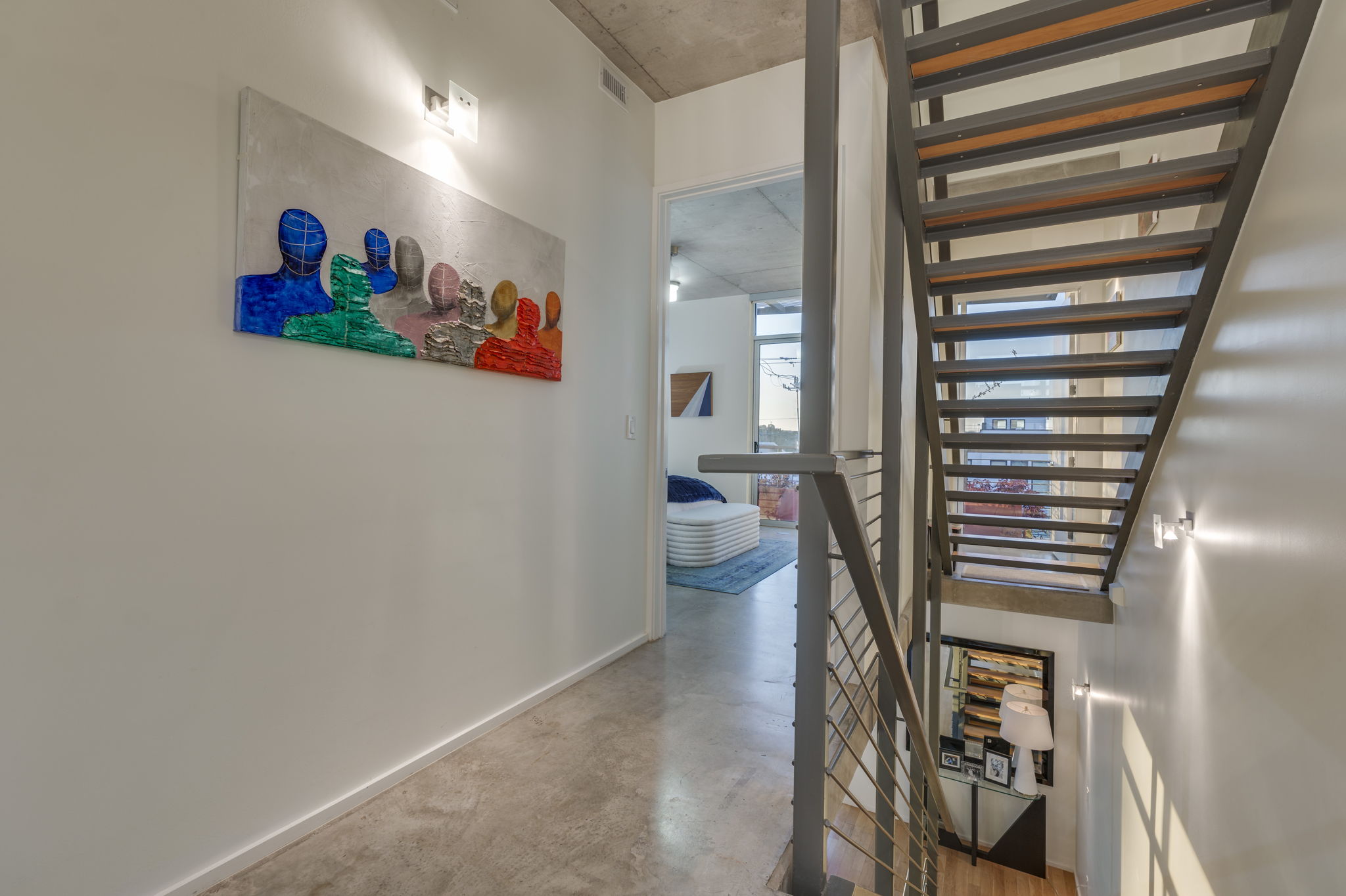 2301 South 5th Street, Unit 5 Austin, TX 78704 - Photo 22 of 39 Hallway stairs featuring hardwood / wood-style floors